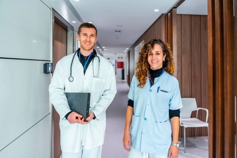 Portrait of two members of medical staff of the hospital standing in the corridor