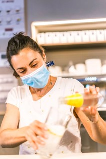 Photo session with a waitress with a face mask in a bar. New normality, security measures after the