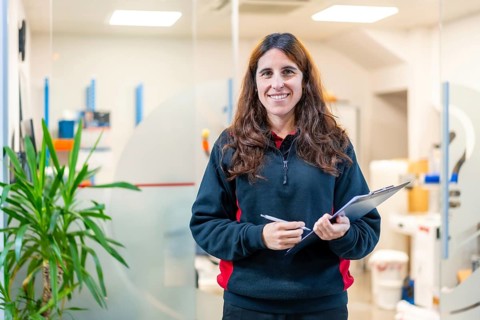 Portrait of a female smiling engineer in a modern cnc factory