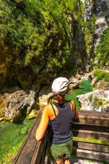 Woman admiring tolmin gorges canyon with thermal spring in slovenia, europe, during sunny summer