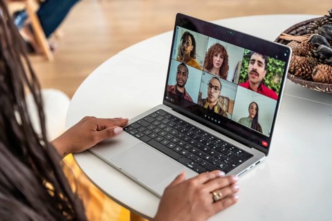 Woman participating in a virtual group therapy session on her laptop, connecting with a diverse