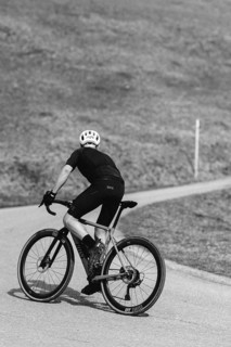 Road bike rider in spring in the Allgäu against the picturesque backdrop of the Alps, Bavaria,