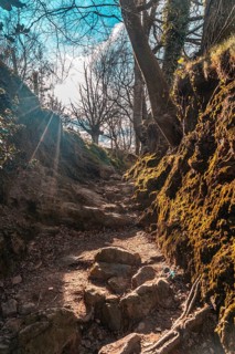 Mud ramps on the trail of Mount Adarra in Guipuzcoa with sunshine above. Basque Country