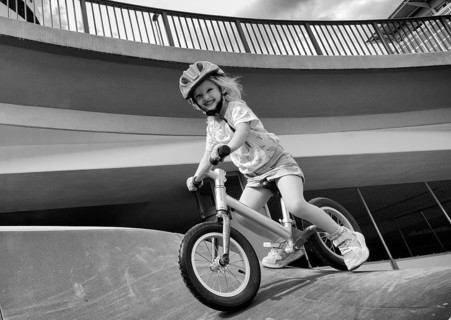 Girl, blonde, 3 years, laughing, riding with bicycle, bike, crash helmet, subway, urban, concrete,