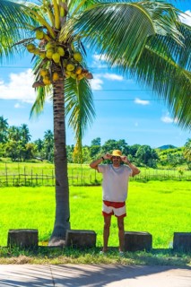 Young man wearing a hat and summer clothes enjoying a sunny day in coron island, philippines, with