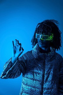 Software engineer wearing futuristic glasses using augmented reality interface making ok sign on