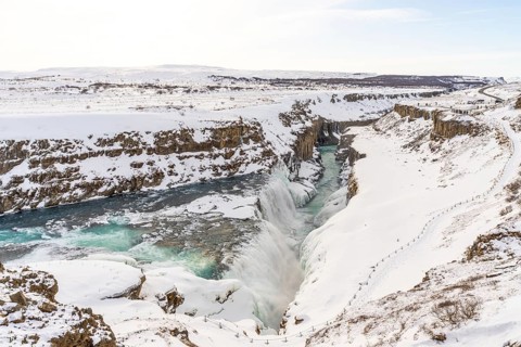 Beautiful snowy and frozen Gullfoss waterfall in the cold Icelandic winter without people