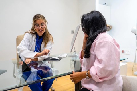Doctor in a medical center explaining health information to a patient during a healthcare