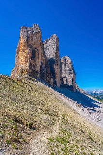 Scenic view of the tre cime di lavaredo mountain peaks with hiking trail in the dolomites, italy