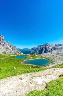 Breathtaking view of alpine lakes nestled amidst the majestic peaks of the dolomites, inviting