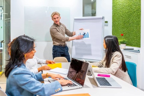 Diverse team of managers analyzing growth strategies during a productive meeting in a modern