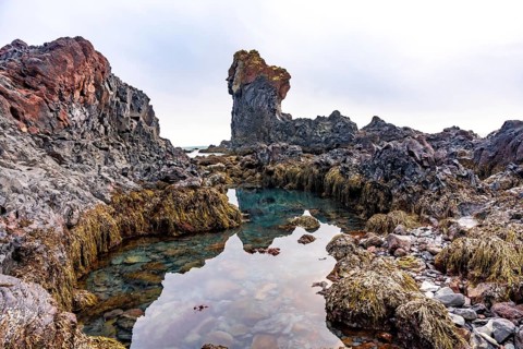Picturesque rock formations by the sea at Djupalonssandur beach on the Snaefellsnes peninsula in