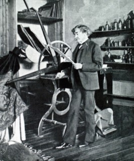 Painter James McNeil Whistler standing by his etching press (1903)