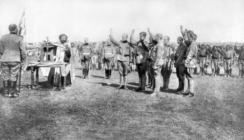 World War I. Serb volunteers pledging an oath before the flag and the Orthodox priest at the moment of enlisting on the Russian front (1918)