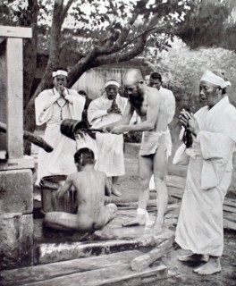 During the death throes of Japanese Emperor Yoshi-Hito, representatives of a Buddhist sect proceding with  purification ceremonies before participating in prayers for the sovereign (1927)