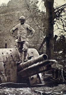 World War I. At Herbecourt, in the Somme, a telephone operator who helped adjust the aim, stands atop a German gun that he helped spot