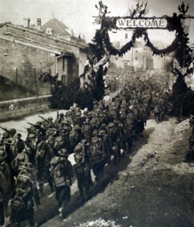 World War I. An American battalion marching through a village in the Meuse on its way to the front