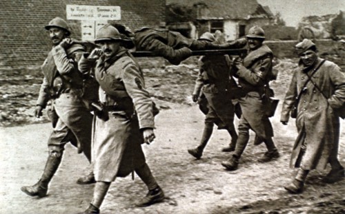 World War I. At the front, French soldiers carrying a wounded English soldier