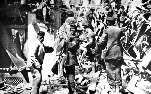 World War I. After a German bombardment, rescue workers remove the bodies of two little girls from the ruins (1915)