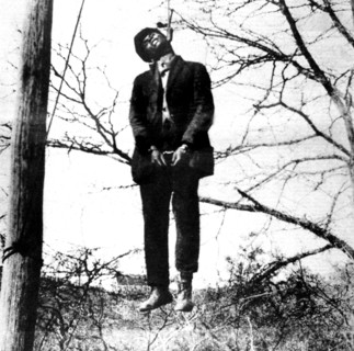 Lynching scene in Texas, 1930. A black man, accused of having attacked a white woman, is hanged immediately.