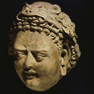 Demon with stylized leonine headdress, moulded clay