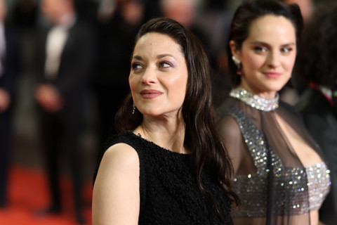 Noémie Merlant (in custom Louis Vuitton) and Marion Cotillard (in custom Chanel) attend the "Roma