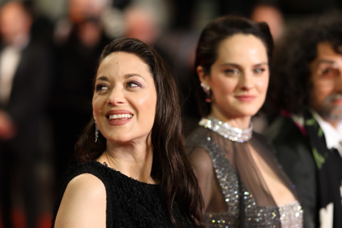 Noémie Merlant (in custom Louis Vuitton) and Marion Cotillard (in custom Chanel) attend the "Roma