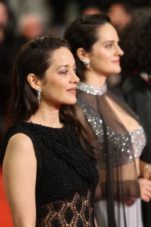 Noémie Merlant (in custom Louis Vuitton) and Marion Cotillard (in custom Chanel) attend the "Roma