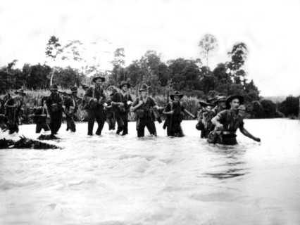 Australian soldiers fording a river in New Guinea, June 14,1944