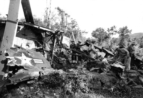 South Vietnam soldiers around a destroyed American tank.