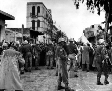 Soldiers of The United Nations Emergency Force retaining demonstrators in Gaza, 1957