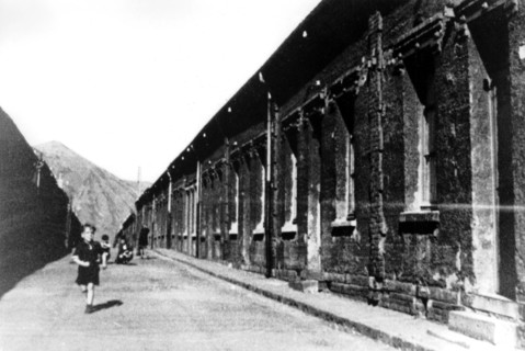Child running before the miners' terraced houses in Henin-Lietard