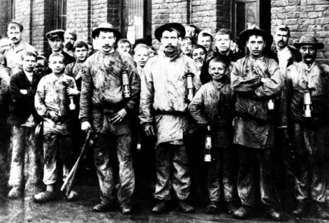 Group of children and men working in the mine of Denain, France
