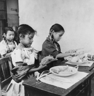 Mexican girls preparing fish tamales
