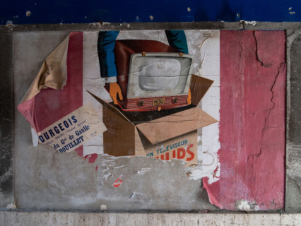 Torn advertising poster