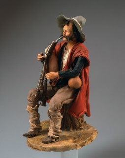 Nativity scene figurine: shepherd playing the pipes