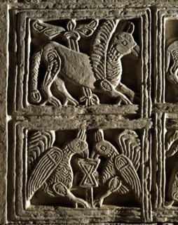 Griffin and birds facing each other around the Chalice of life