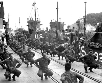 GI's of the assault troops "limber up" aboard a landing craft prior to their departure for France (June 6, 1944)