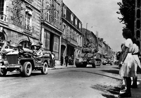 U.S troops pass Brehal (Frace) on their way to capture Avranches