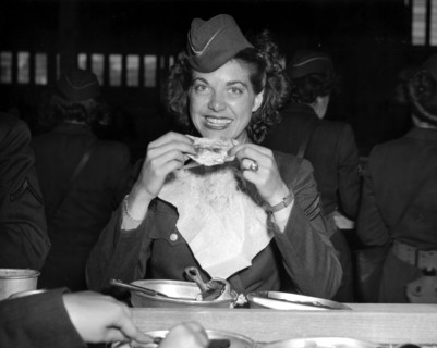 Caporal du corps d'armée féminin U.S. savourant son premier repas au Havre.
(22 juillet 1945)