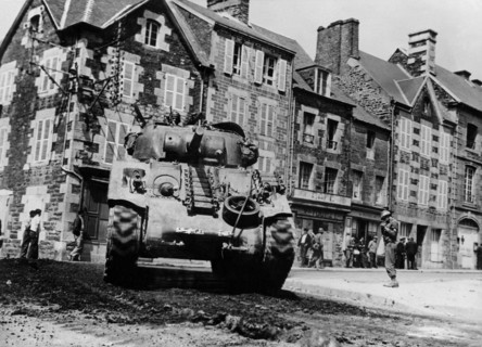 A U.S.  tank moves up to front in Brehal (France) Summer 1944