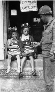Un GI donne des sucreries à deux petites normandes