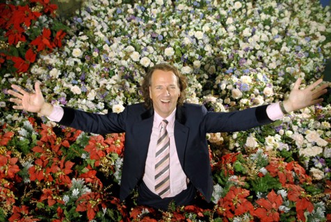 (dpa) - Dutch star violinist Andre Rieu smiles while standing in a sea of artificial flowers in