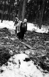 Children walking over a ground devastated by military exercises