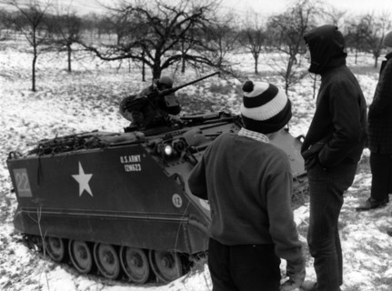 Village youth examines US armoured personnel carrier during German-American manoeuvre "Silberkralle"