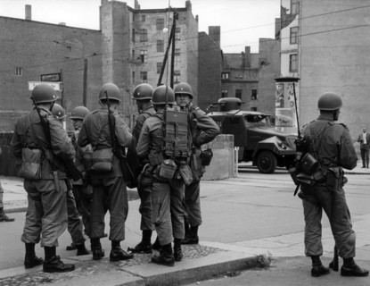 US soldiers in front of water cannon of People's Police at border crossing point Friedrichstrasse in Berlin 1961