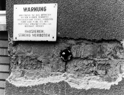 Warning sign at decrepit apartments of the US Army