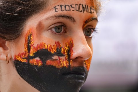 Argentina, Buenos Aires: A demonstrator who has symbolically painted a kangaroo running away from the fire on her face is taking part in a protest against climate policy in front of the Australian Emb...