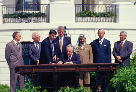 Minister of Foreign Affairs of Israel Shimon Peres puts his signature on the agreement during the