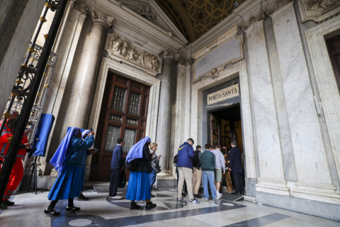 People enter the Basilica of Santa Maria Maggiore through the Holy Door.